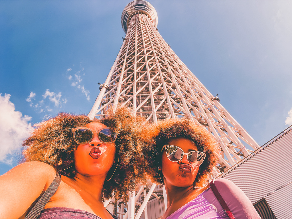 women at the Tokyo Skytree in Japan taking tourist photos